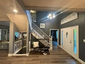 Clean hardwood floors, white staircase railings, and bright interior walls in modern home
